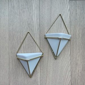 Set of two white geometric ceramic and brass metal wall hanging plant holders.